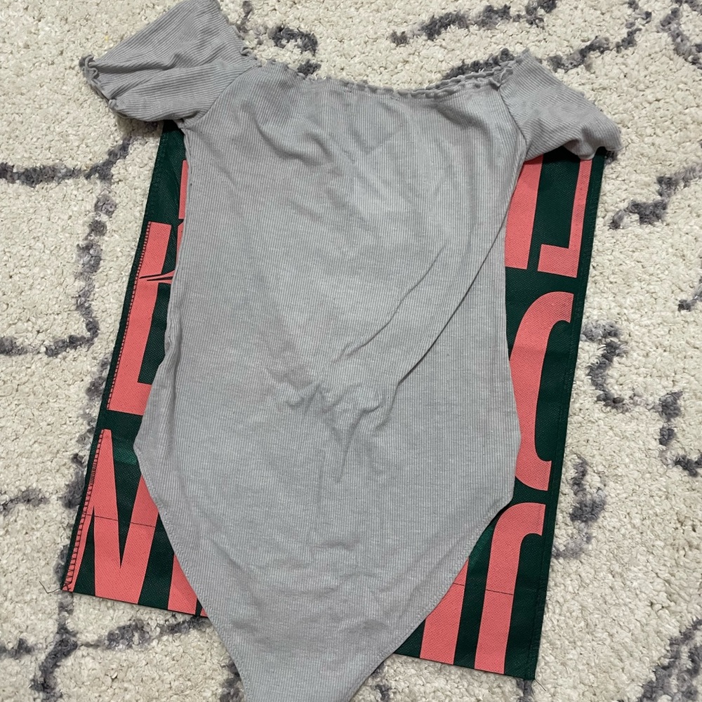 Grey off the shoulder body suit.